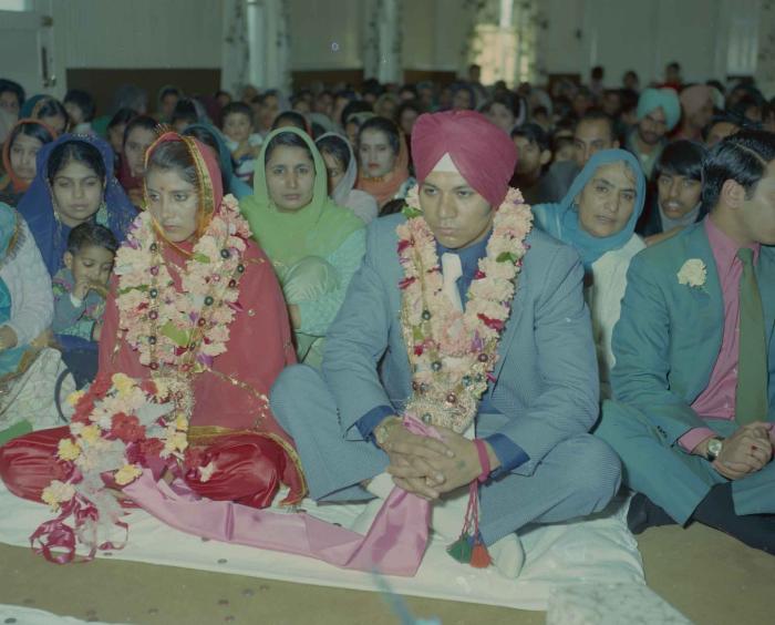 [Photo of Daljit Dhaliwal, an unidentified bride and wedding guests]