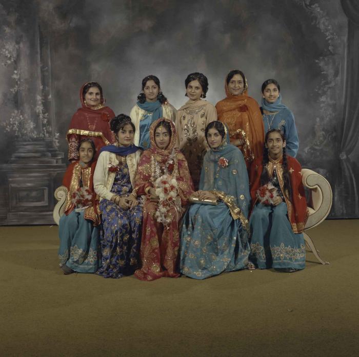 [Group portrait of Demindar Gill and nine unidentified women]