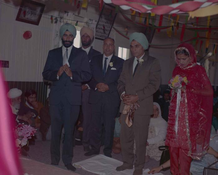 [Photo of an unidentified groom, an unidentified bride and wedding guests]
