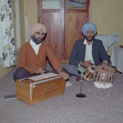[Photo of two unidentified men playing instruments]