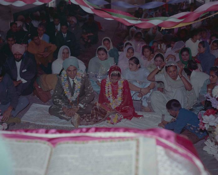 [Photo of an unidentified groom, an unidentified bride and wedding guests]