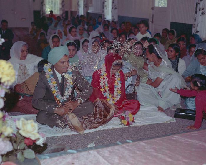 [Photo of an unidentified groom, an unidentified bride and wedding guests]