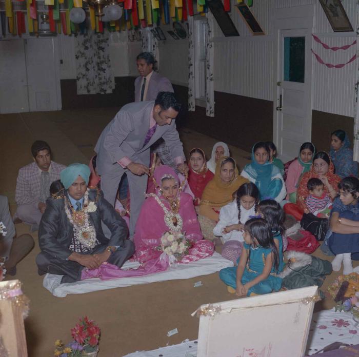 [Photo of Harjinder K. Sidhu, Jagat S. Gill and wedding guests]