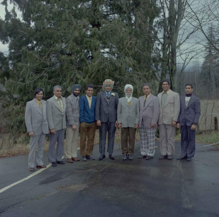 [Photo of Jagat S. Gill and eight unidentified men]