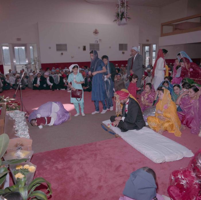 [Photo of Harjinder Gill and wedding guests]