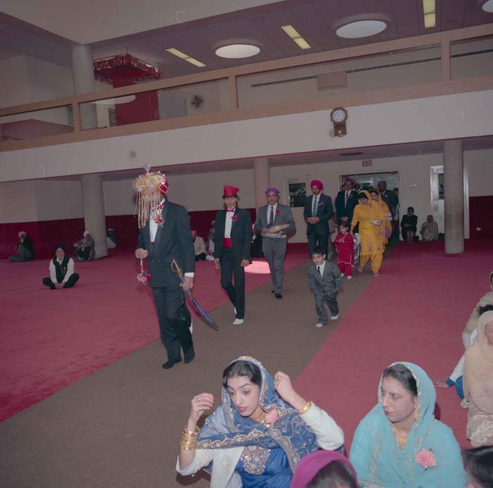[Photo of Harjinder Gill and wedding guests]