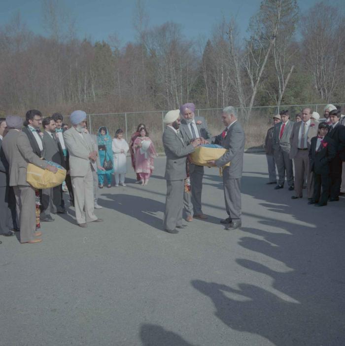 [Photo of unidentified group of weddings guests in the parking lot]