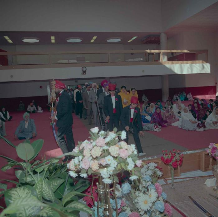 [Photo of Harjinder Gill and wedding guests]