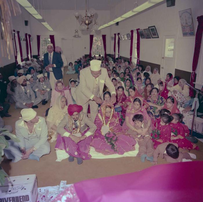 [Photo of David Gill, Kamaljeet Grewal and the wedding guests]