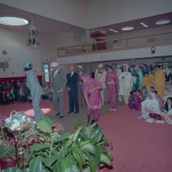 [Photo of wedding guests in a procession to the front of the Gurdwara]