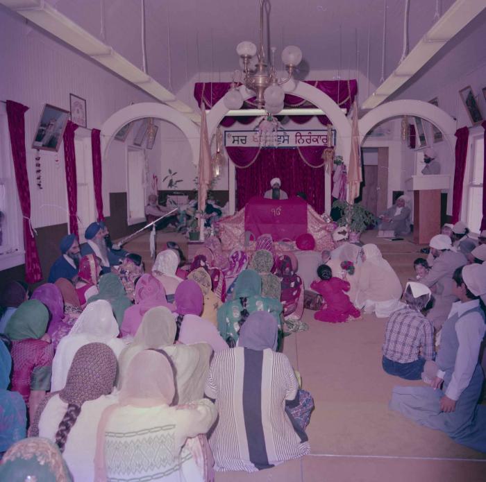 [Photo of David Gill, Kamaljeet Grewal and the wedding guests facing the Granthi]