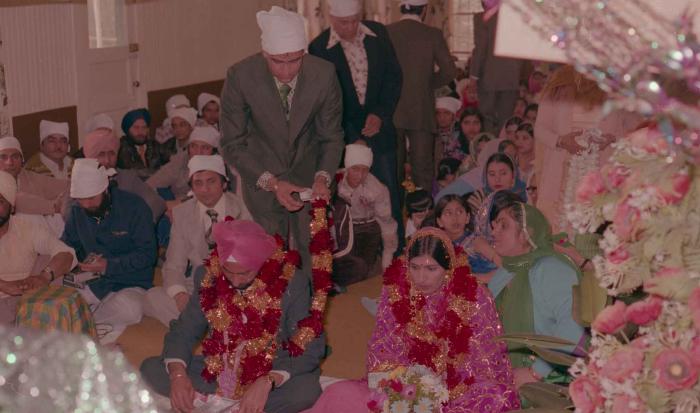 [Photo of Baljinder Gill, Gurcharah Dhaliwal and the wedding guests]