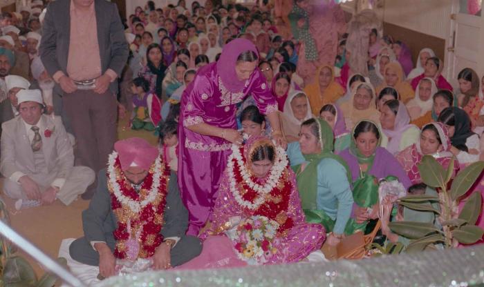 [Photo of Baljinder Gill, Gurcharah Dhaliwal and the wedding guests]