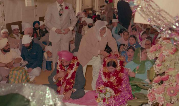 [Photo of Baljinder Gill, Gurcharah Dhaliwal and the wedding guests]
