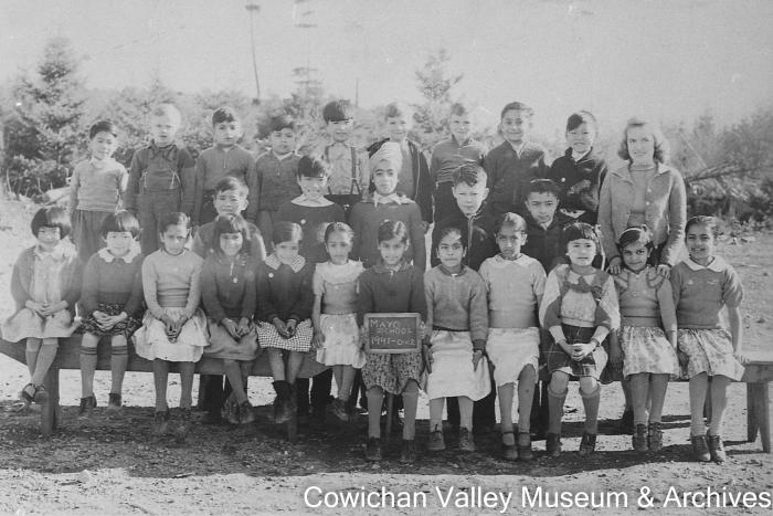 [Group of unidentified school children and teacher posing for class portrait]