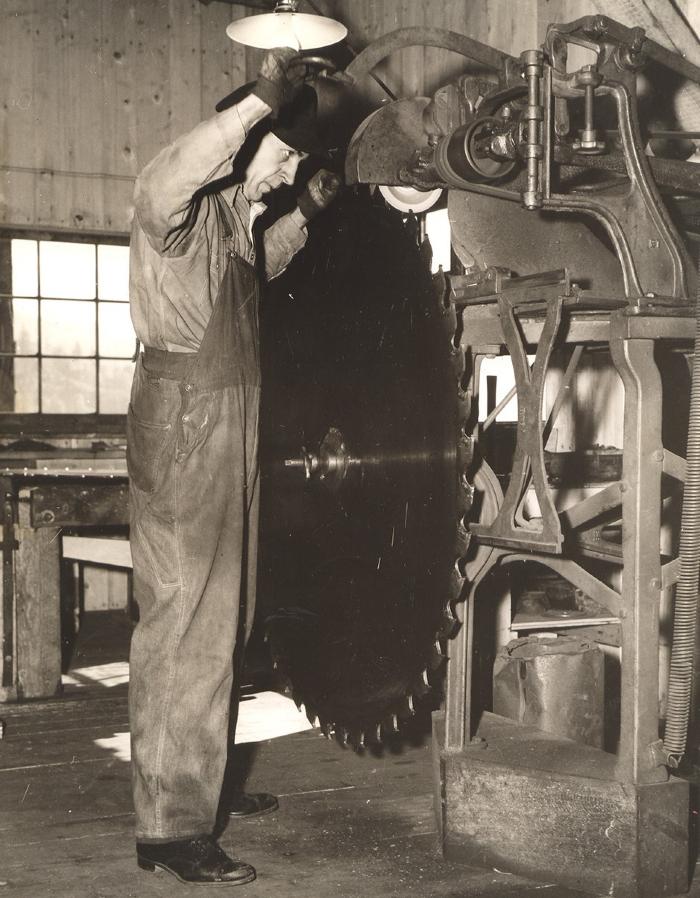 Millwright sharpens saw blade