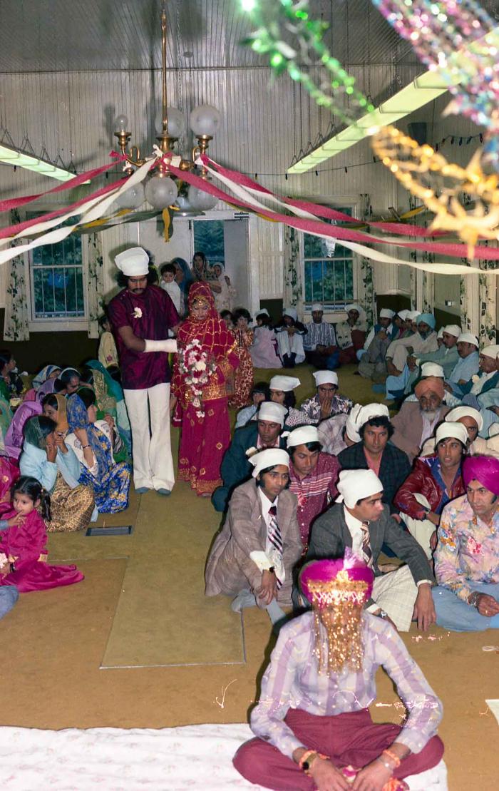 [Group photo of Ajmar Singh Bapari and Sandhu Avdar with wedding guests]