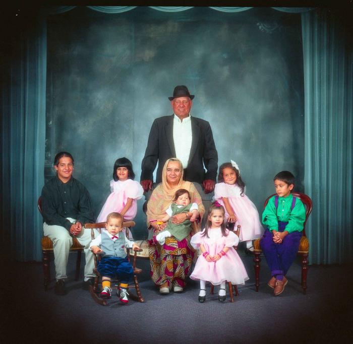 [Photo of Surinder Kaur and Paul Dhaliwal with their grandchildren]