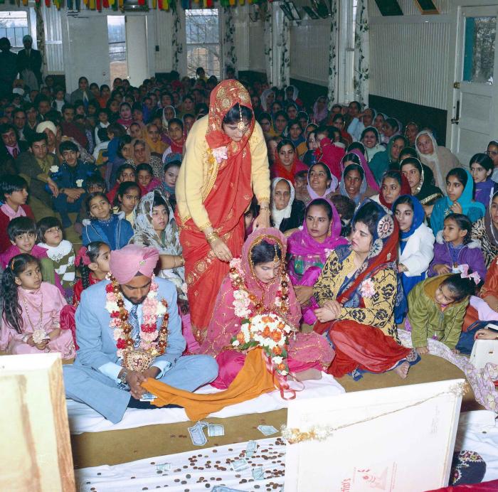 [Group photo of Braich and unidentified  bride with wedding guests]