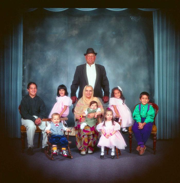 [Photo of Surinder Kaur and Paul Dhaliwal with their grandchildren]