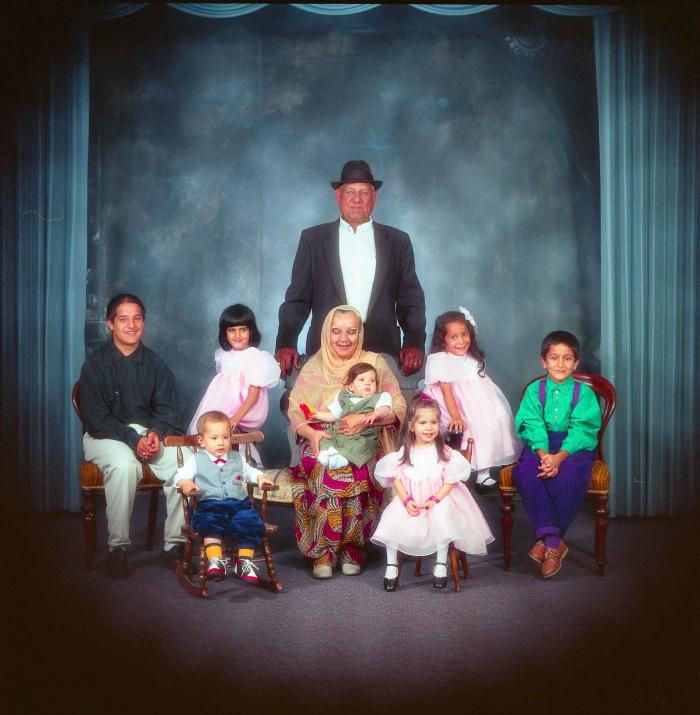 [Photo of Surinder Kaur and Paul Dhaliwal with their grandchildren]