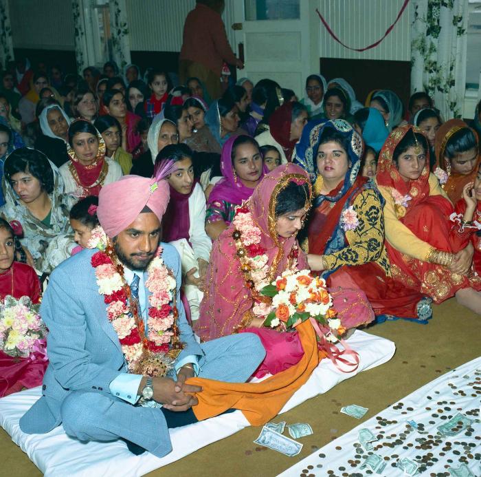[Group photo of Braich and unidentified  bride with wedding guests]