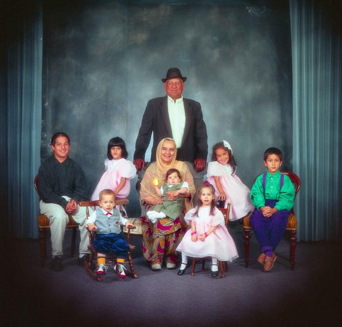 [Photo of Surinder Kaur and Paul Dhaliwal with their grandchildren]