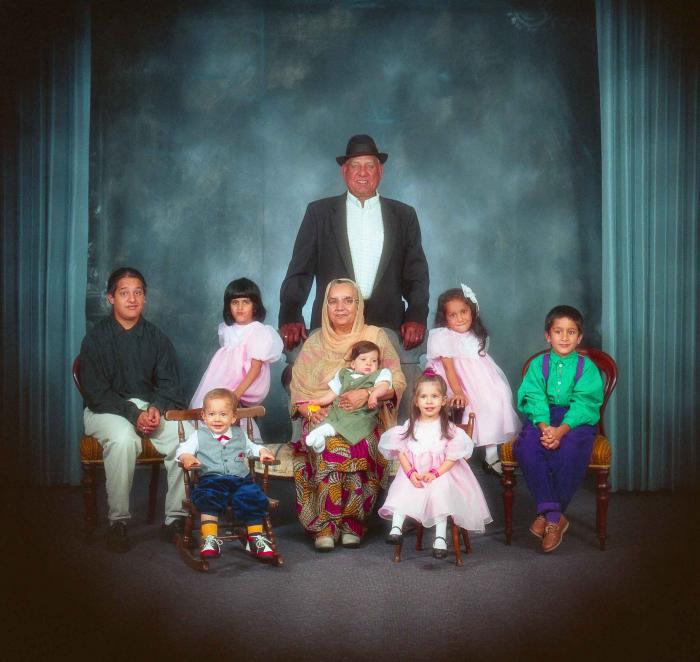 [Photo of Surinder Kaur and Paul Dhaliwal with their grandchildren]