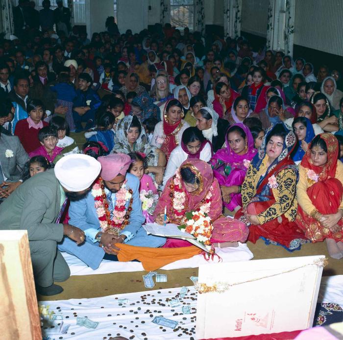 [Group photo of Braich and unidentified  bride with wedding guests]