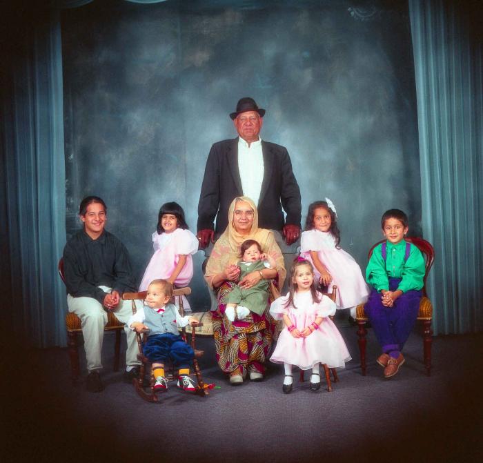 [Photo of Surinder Kaur and Paul Dhaliwal with their grandchildren]