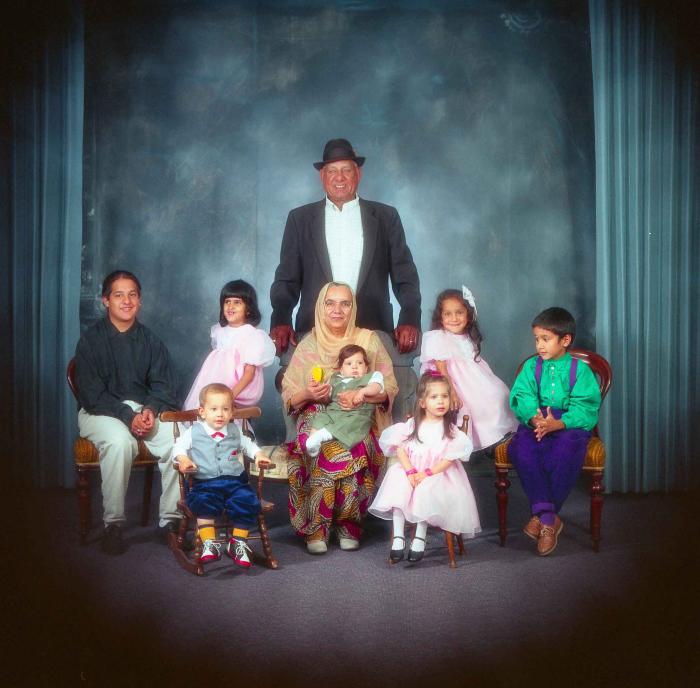 [Photo of Surinder Kaur and Paul Dhaliwal with their grandchildren]