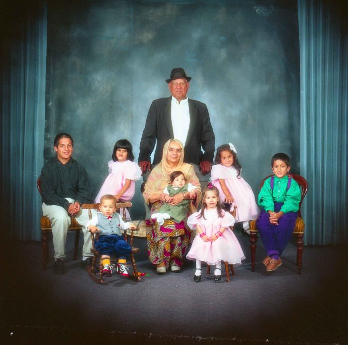 [Photo of Surinder Kaur and Paul Dhaliwal with their grandchildren]
