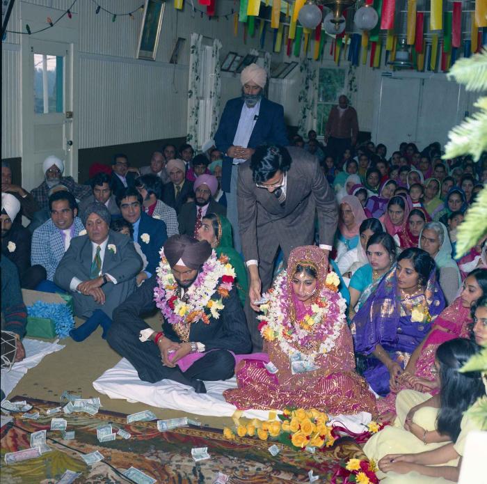 [Group photo of Balbir Khangura and Baljit Gill with wedding guests]