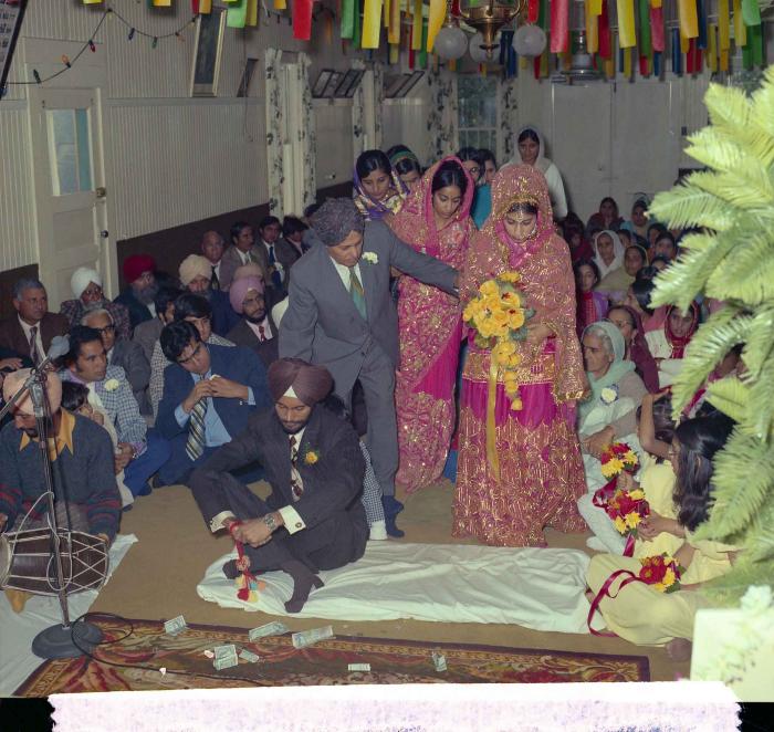 [Group photo of Balbir Khangura and Baljit Gill with wedding guests]