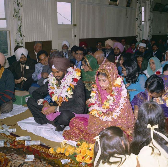 [Group photo of Balbir Khangura and Baljit Gill with wedding guests]
