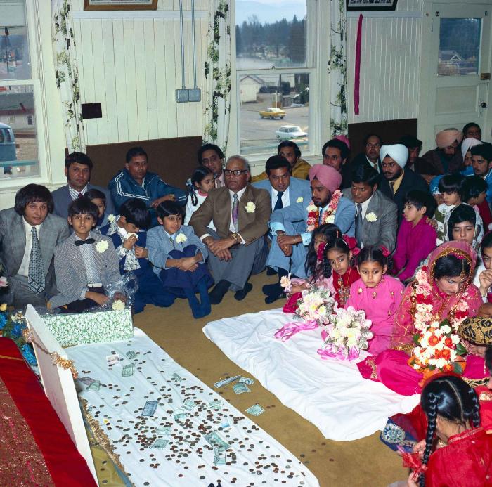 [Group photo of Braich and unidentified  bride with wedding guests]