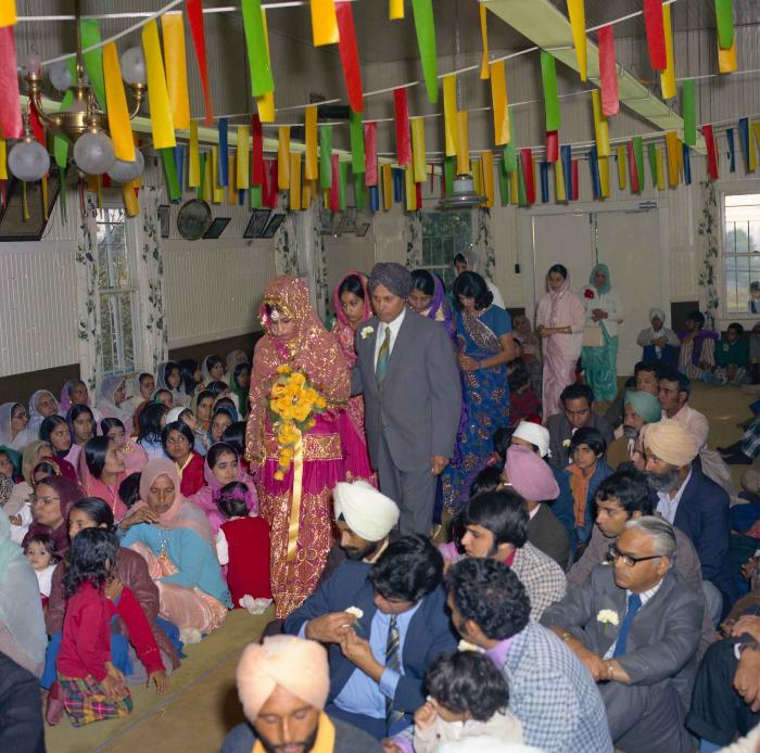 [Group photo of Baljit Gill with wedding guests]