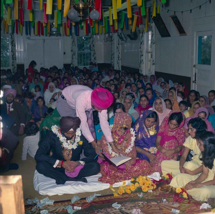 [Group photo of Balbir Khangura and Baljit Gill with wedding guests]