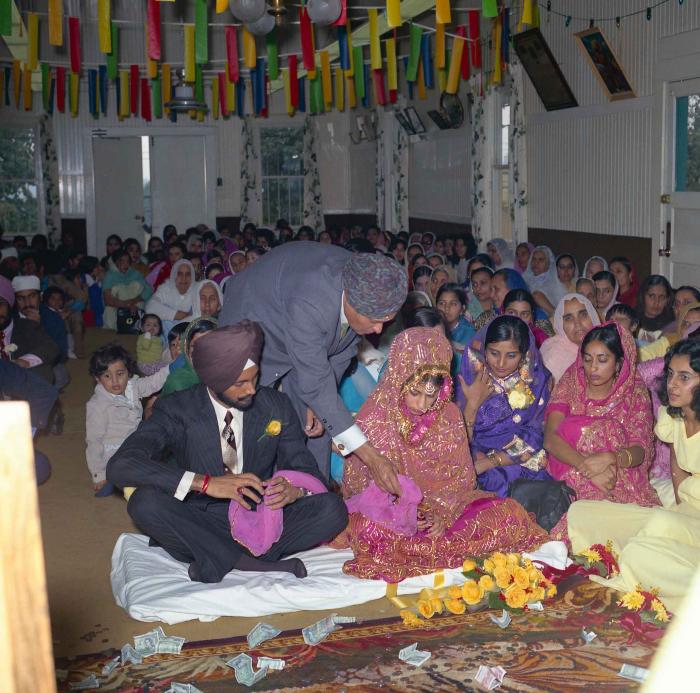 [Group photo of Balbir Khangura and Baljit Gill with wedding guests]