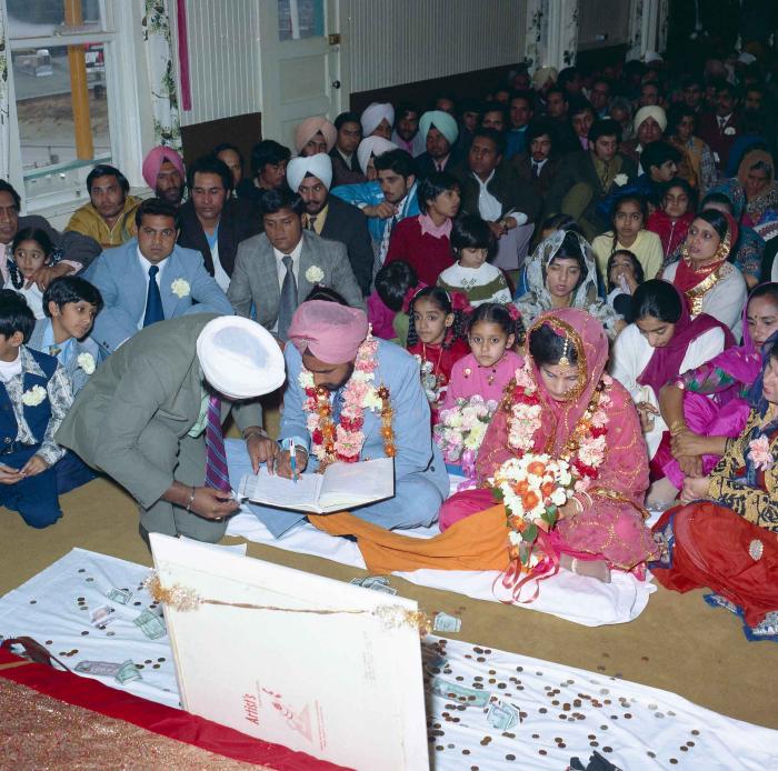 [Group photo of Braich and unidentified  bride with wedding guests]