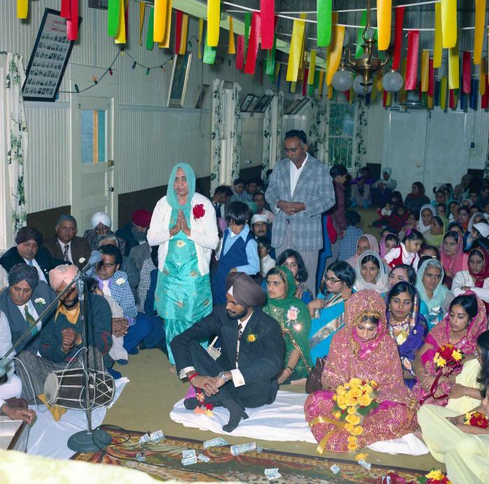 [Group photo of Balbir Khangura and Baljit Gill with wedding guests]