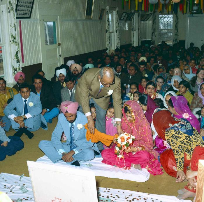 [Group photo of Braich and unidentified  bride with wedding guests]