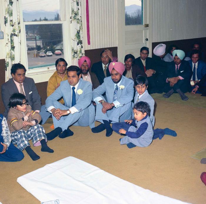 [Group photo of Braich with wedding guests]