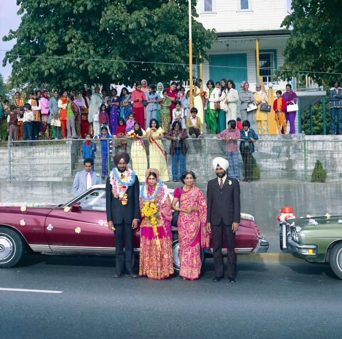 [Group photo of Balbir Khangura and Baljit Gill with wedding guests outside Gur Sikh Temple]