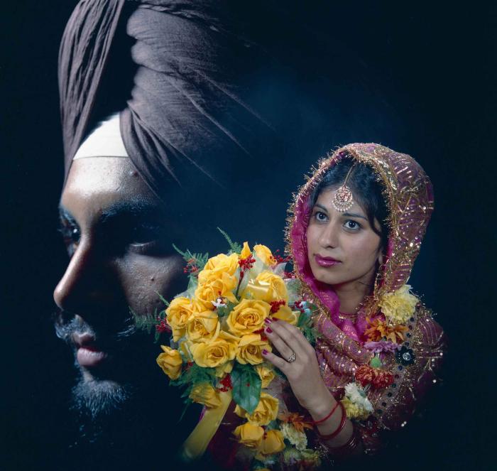 [Portrait of Baljit Gill with the face of Balbir Khangura reflected in background]