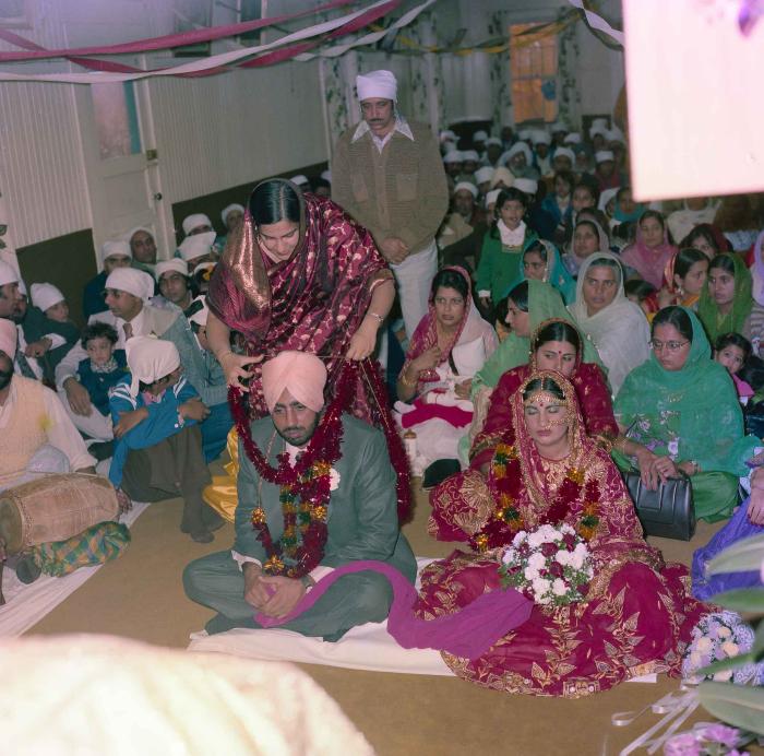 [Group photo of Inderjit Cheema and unidentified  bride with wedding guests]