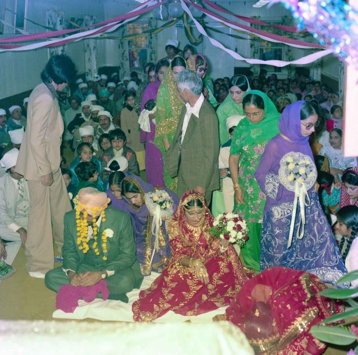 [Group photo of Inderjit Cheema and unidentified  bride with wedding guests]