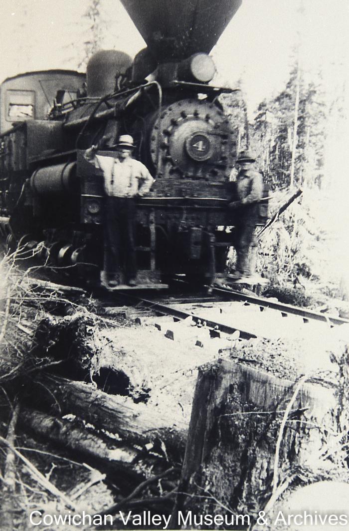 [Two unidentified men standing on locomotive number four]