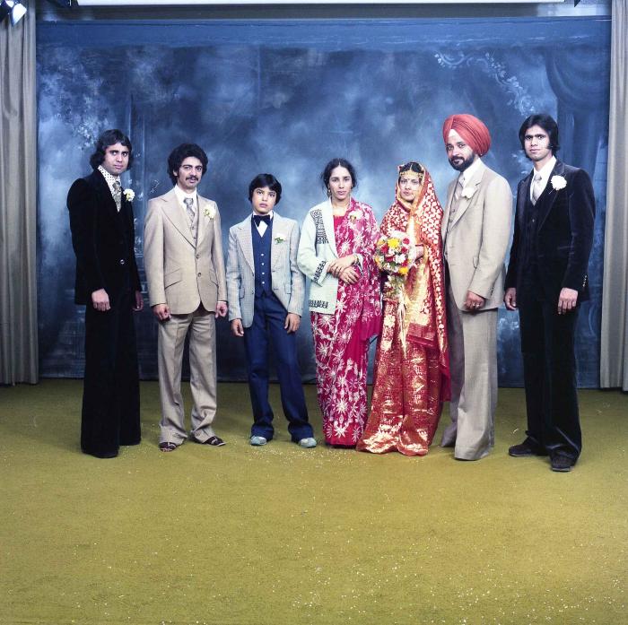 [Group photo of Parm Cheema and Swaren Dhaliwal with wedding guests]