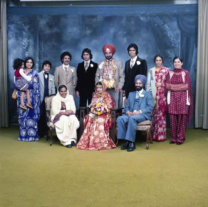 [Group photo of Parm Cheema and Swaren Dhaliwal with wedding guests]